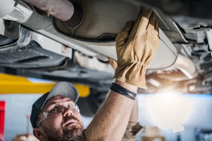 Picture of a mechanic working in a exhaust